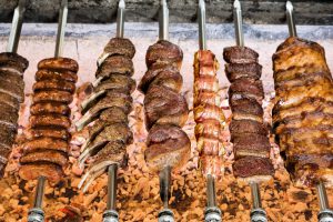 grilled meats on skewers over open flame 