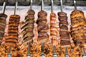 grilled meats on skewers over open flame 