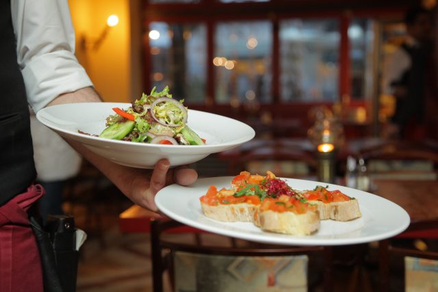 Restaurants New Year's Eve The Summit Drink: Waiter carring two plates full of colorful food