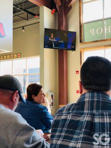 people looking at a tv