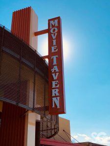 movie tavern sign with sun in background