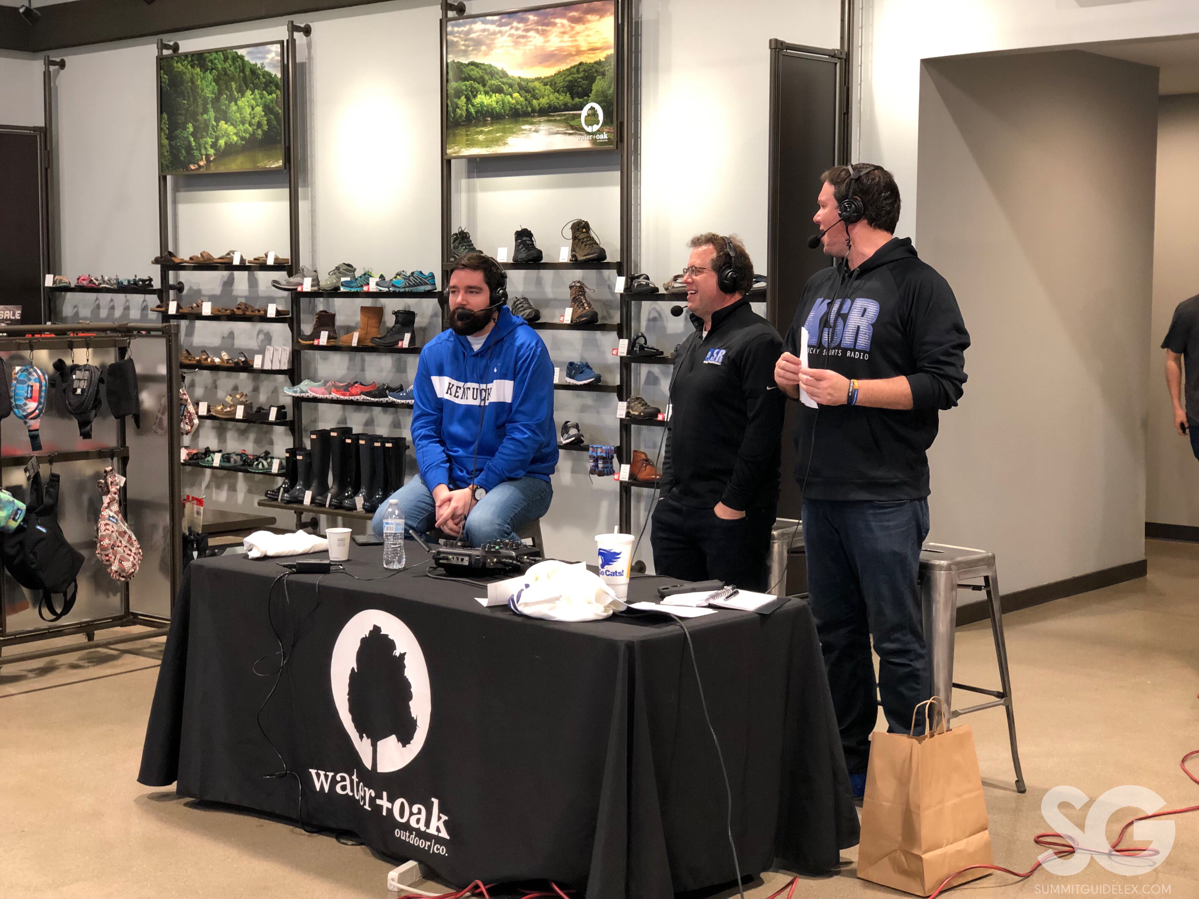 Sports Radio: three guys with headphones on broadcasting a radio show with blue and black sweatshirts