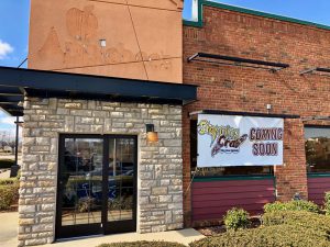 old Applebee's building with a storming crab coming soon banner