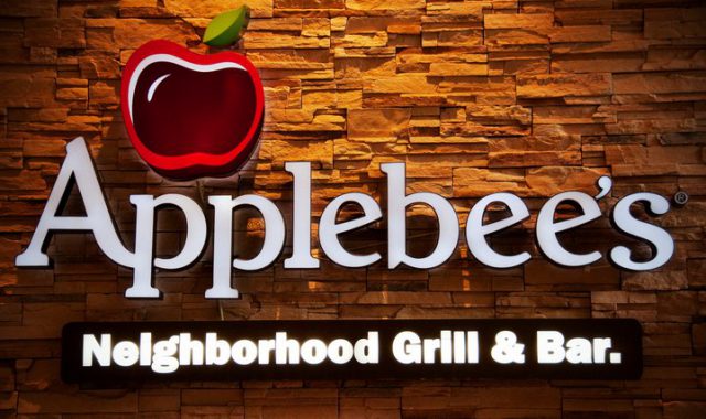 Applebee's neighborhood grill and bar sign with a textured background