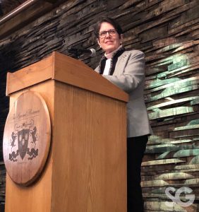 Women Leading Kentucky: woman in a blazer talking at a podium