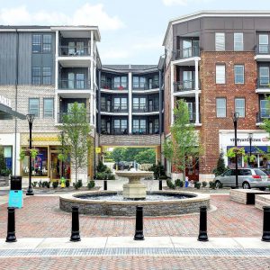 The Henry: apartment complex with retail shops on first floor and a fountain in front