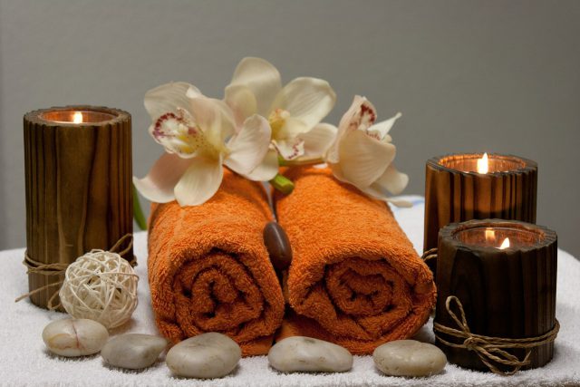 Lexington Green Mall: two burnt orange towels with flowers, pebbles, and candles