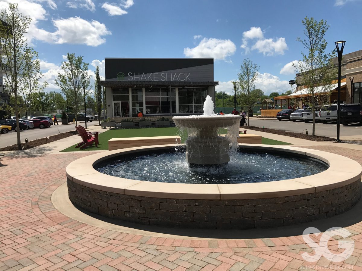 Sounds of Summer: fountain with a green space and shake shack behind