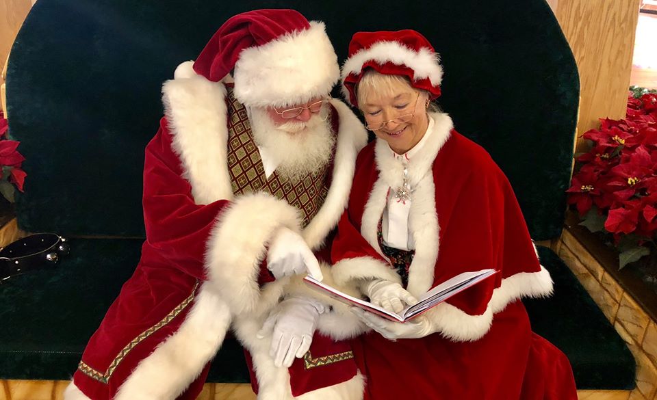 Mr. & Mrs. Claus reading a book