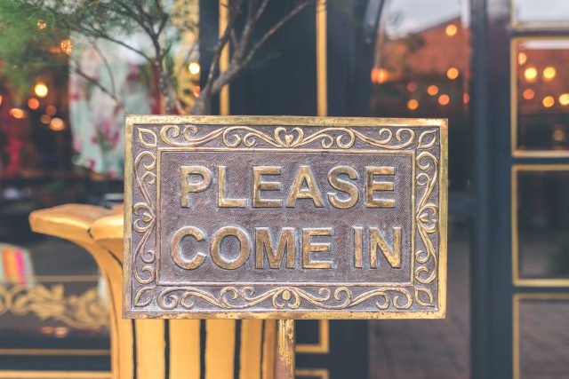 Summit Christmas: a metal sign that says please come in